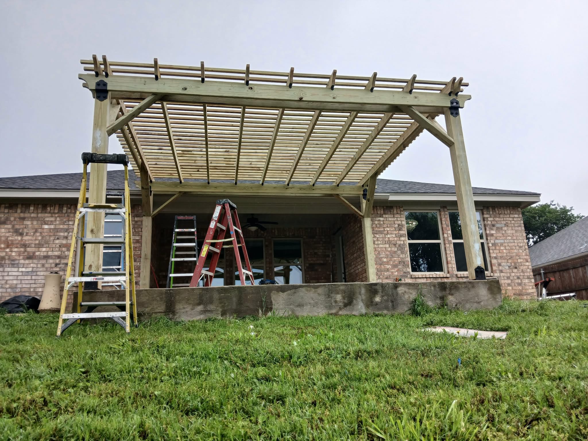 After: pergola completed with wood slat roof