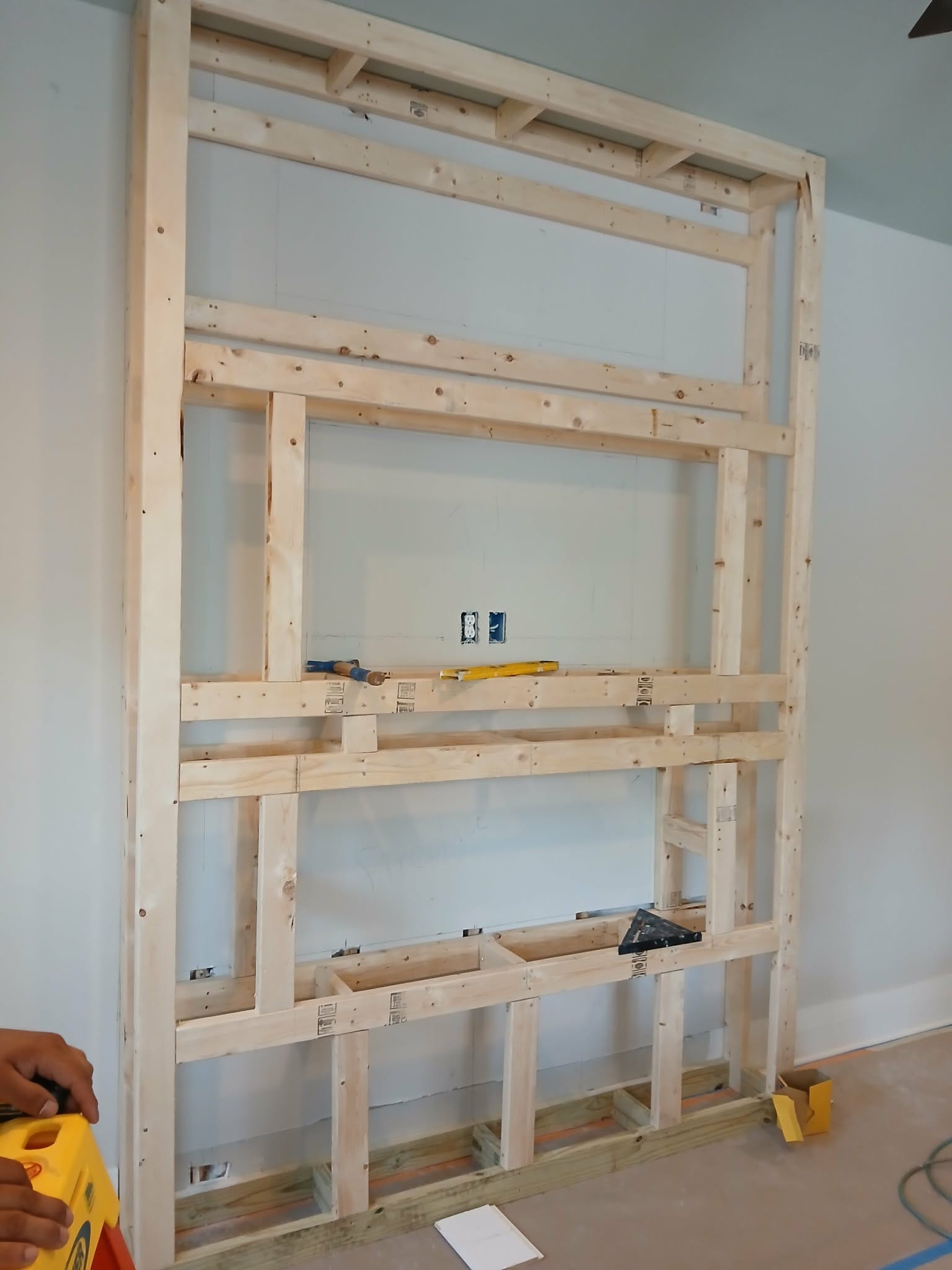 Before: wood framing for custom TV and fireplace wall unit