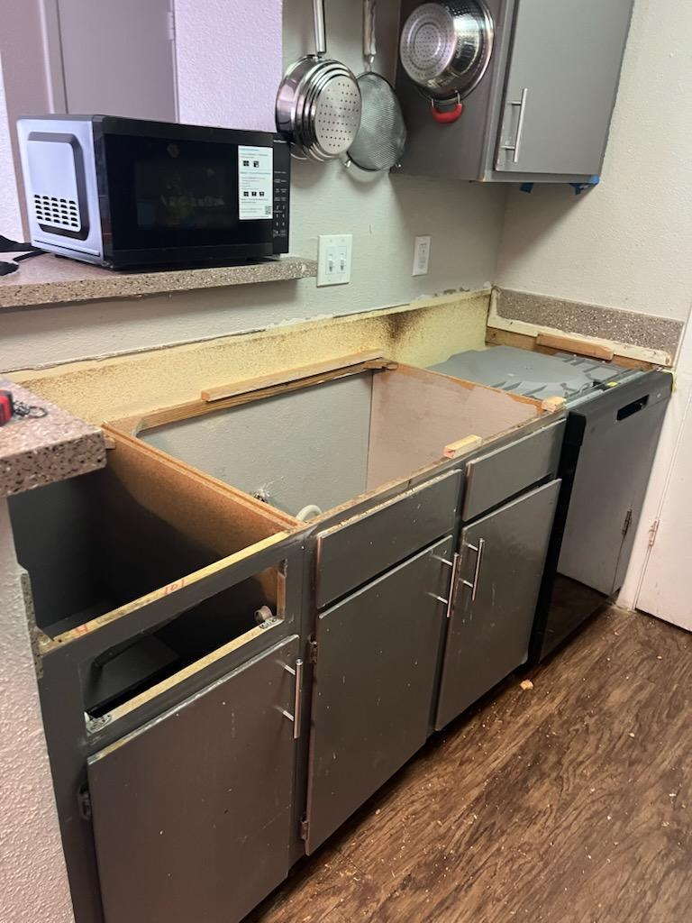 Before: old damaged kitchen cabinets missing doors