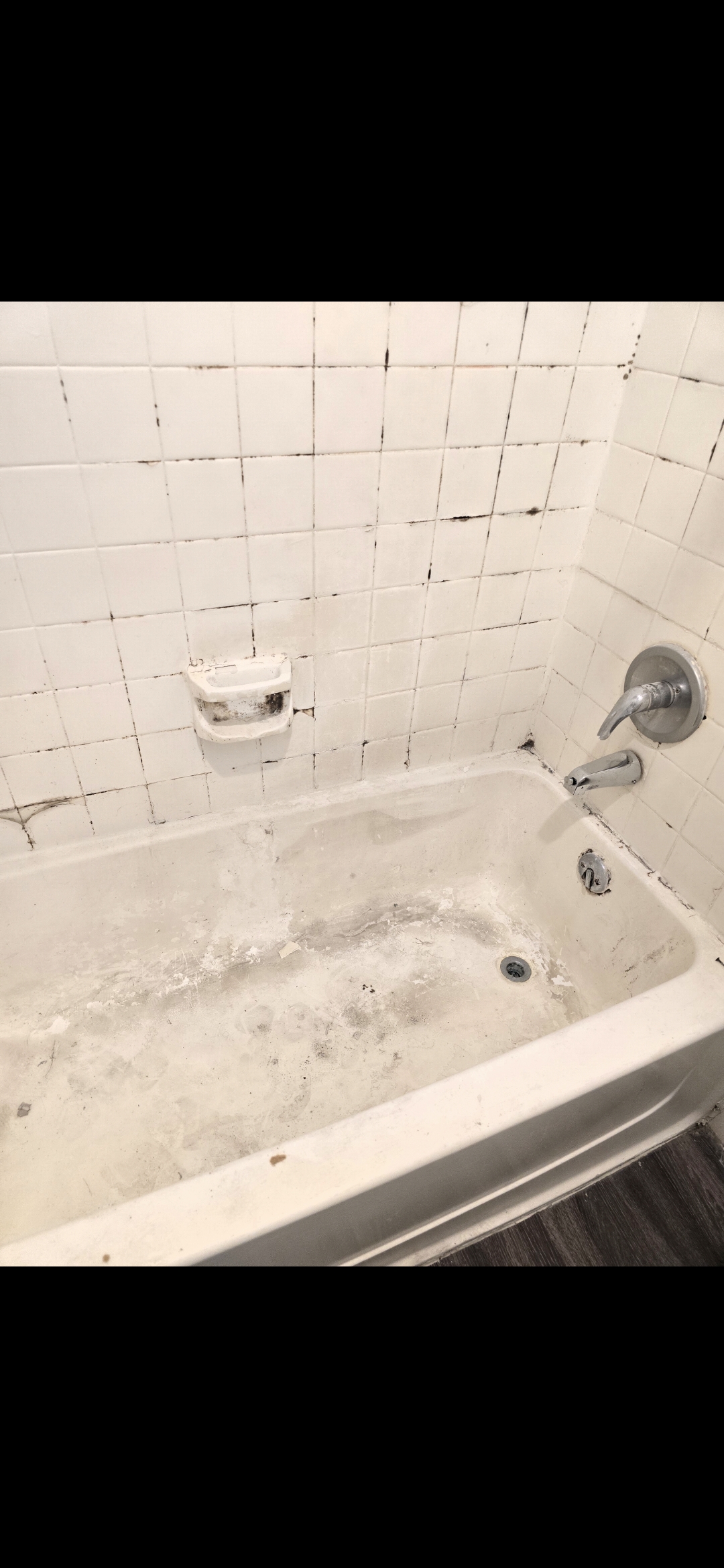 Before: bathtub with old dirty tile and mold